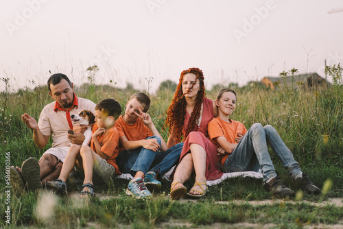 Portrait of a family in nature. Children and parents play in nature. Good time with family on vacation. Happy family day