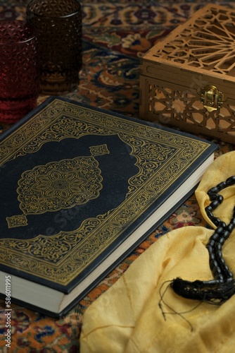 Alqur'an, Qur'an, Kuran or Islamic holy book and prayer beads on arabian background. Ramadhan kareem,  eid mubarak or islamic concept photo