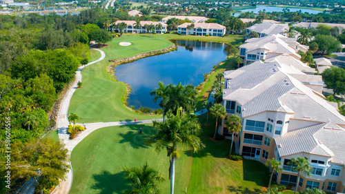 Lake on Golf Course in Gated Community Featuring Luscious Trees Lined with Luxury Real Estate in Naples, Florida