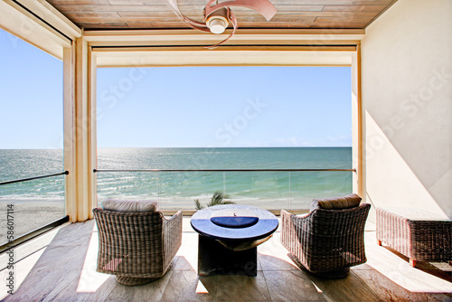 Beach View on Clear Day from Florida Balcony with Outdoor Furniture and Luxury Interiors