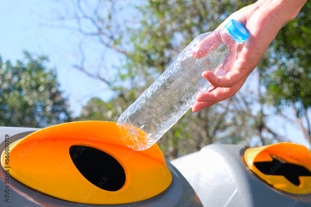 Please throw plastic bottles in the bin. Man littering the bins by