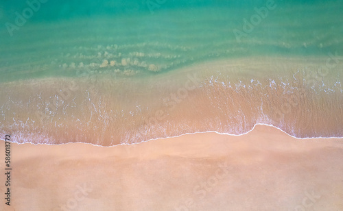 Beach sand background for summer vacation concept. Beach nature and summer seawater with sunlight light sandy beach Sparkling sea water contras