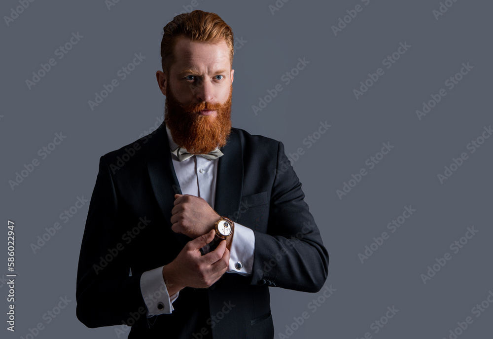 man wearing elegant wrist watch and tuxedo, copy space. tuxedo fashion. handsome bearded man