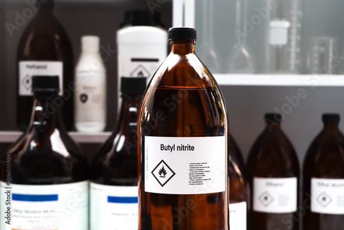Bild auf Leinwand butyl nitrite in glass, Hazardous chemicals and flammable symbols