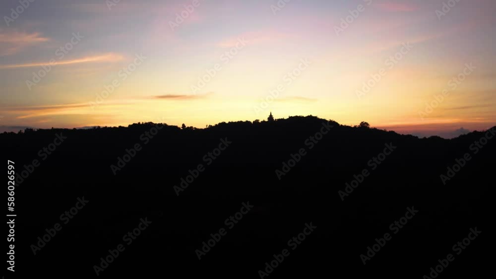 Samui buddist mountain temple from far, sunset, drone Samui buddist mountain temple from far, sunset, drone