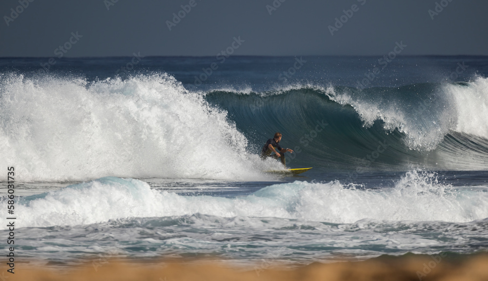 Professional surfer on an ocean wave.