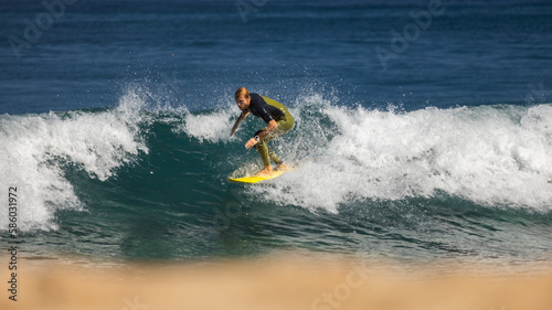 Professional surfer on an ocean wave. © Nikita