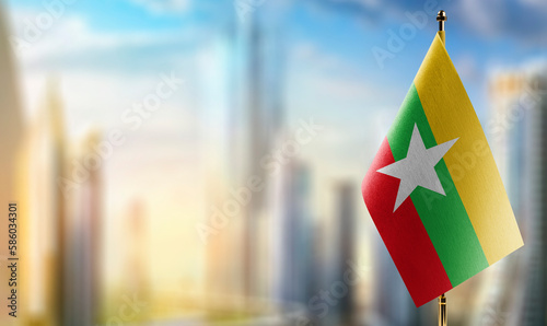 Small flags of the Myanmar on an abstract blurry background