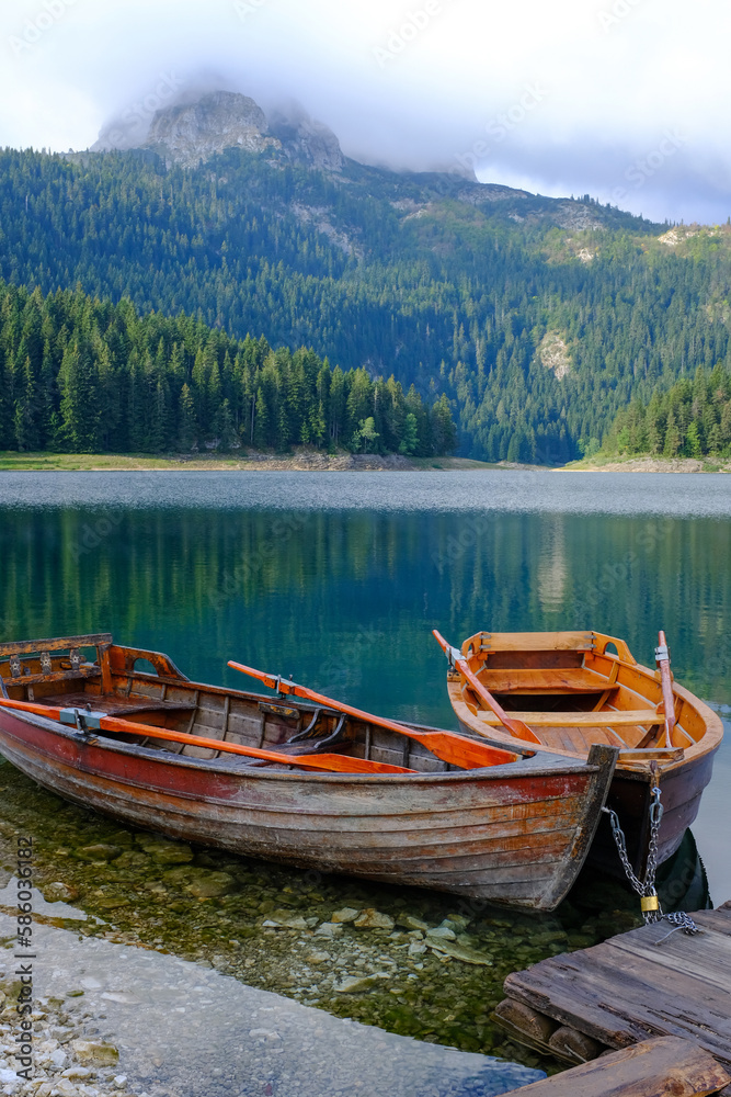 Boats in the water. Black Lake or Crno Jezero. National park Durmitor Mouintains in Montenegro.
