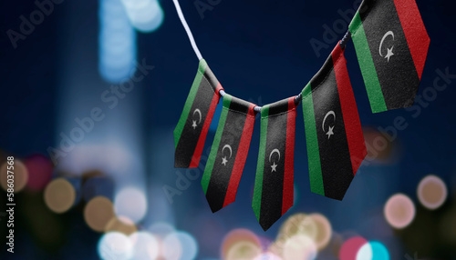 A garland of Libya national flags on an abstract blurred background