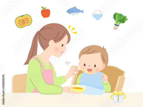 赤ちゃんに離乳食を食べさせるママ