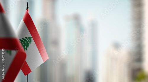 Small flags of the Lebanon on an abstract blurry background