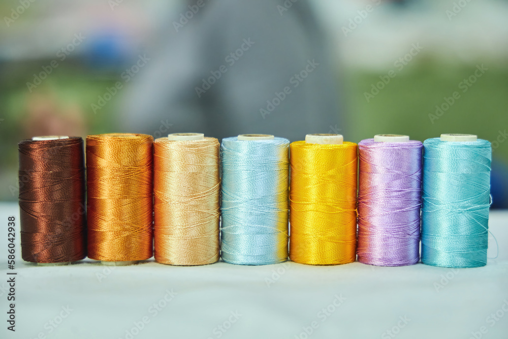 Close - up of coils of threads of different colors and shades for sewing, embroidery and creativity. The concept of Hobbies and crafts. Close - up of coils of threads of different colors and shades for sewing, embroidery and creativity. The concept of Hobbies and crafts.