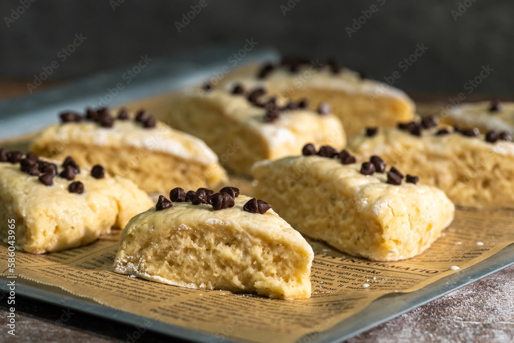 Bakery - Dough for bread or scones is on a parchment paper, prepared for baking. Bakery - Dough for bread or scones is on a parchment paper, prepared for baking.