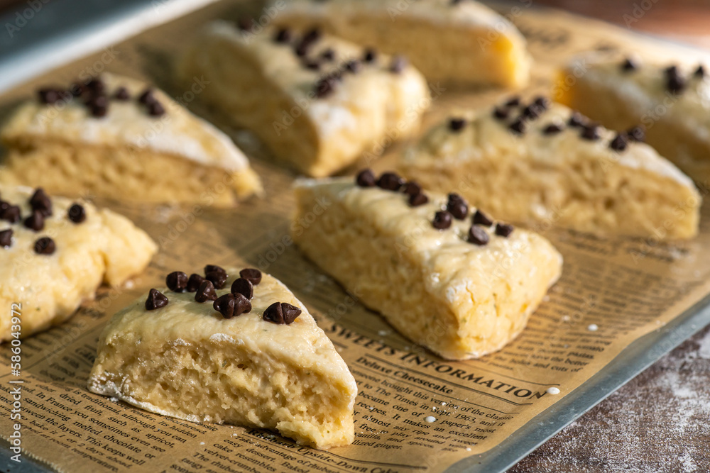 Bakery - Dough for bread or scones is on a parchment paper, prepared for baking. Bakery - Dough for bread or scones is on a parchment paper, prepared for baking.