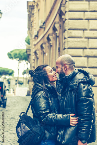  Portrait  of Happy  Tourists  couple   in love traveling at Rome, Italy,    Hugging   at Campidoglio Square.Concept of Italian travel. 