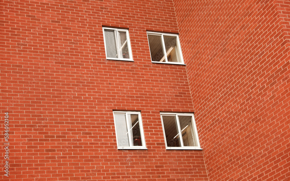 A multi-story brick building featuring a mix of commercial offices and residential apartments, with classic architectural details and large windows. A multi-story brick building featuring a mix of commercial offices and residential apartments, with classic architectural details and large windows.