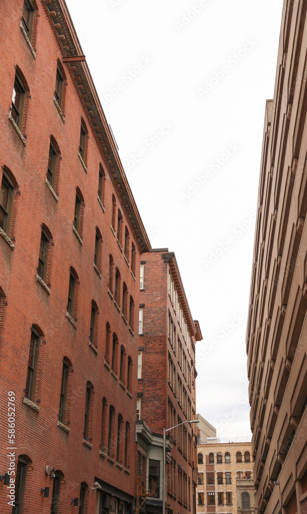 A multi-story brick building featuring a mix of commercial offices and residential apartments, with classic architectural details and large windows.