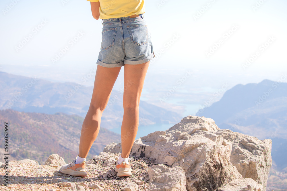woman legs in shorts at the viewpoint mountain scenery in Taurus mountains