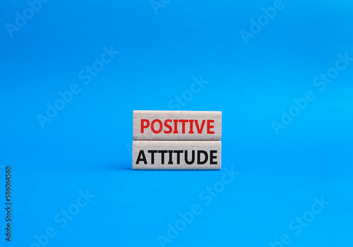 Positive attitude symbol. Concept words Positive attitude on wooden blocks. Beautiful blue background. Business and Positive attitude concept. Copy space.