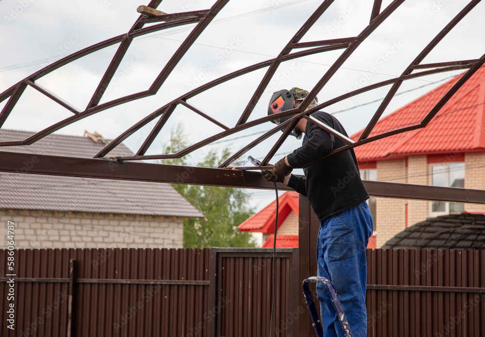 The worker installs the metal on the canopy.