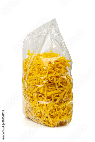 Raw Yellow Italian Pasta in Plastic Packaging, Pappardelle, Fettuccine,Tagliatelle Isolated, Egg Noodles Isolated