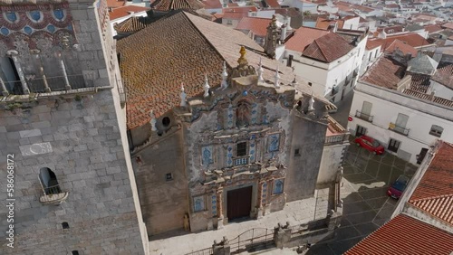 Bird's eye view of a church entrance with tower in a Spanish town square plaza with narrow streets and white houses. Iglesia de San Bartolomé. Jerez de Los Caballeros, Badajoz, Extremadura, Spain