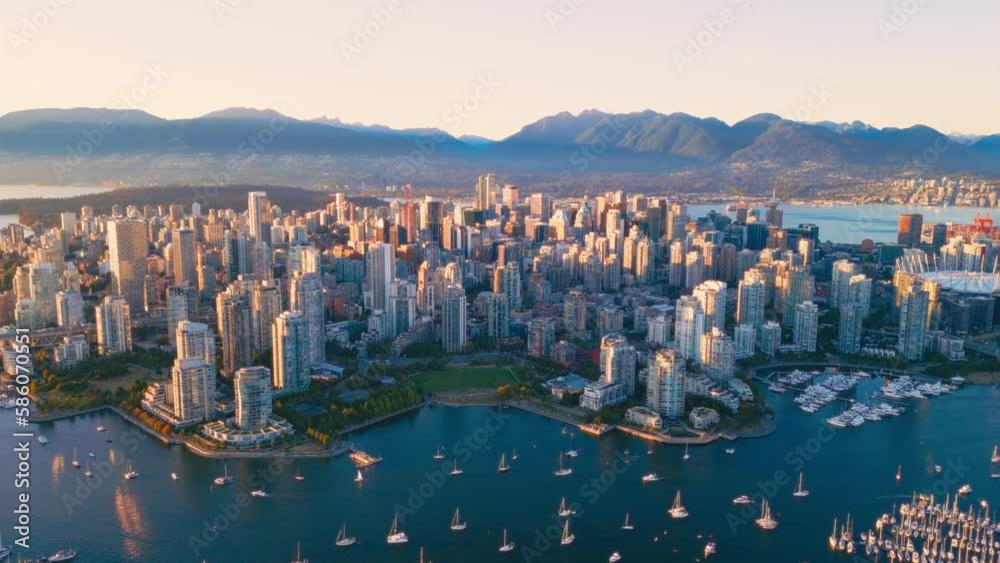 Vancouver downtown skyline aerial pullback reveal shot, BC, Canada at sunset
