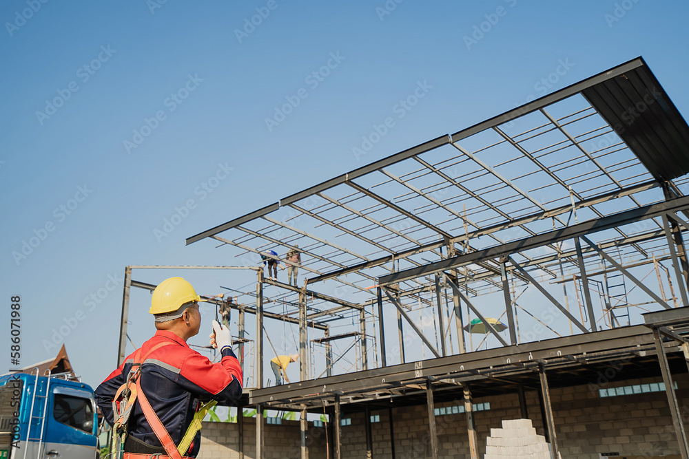 The foreman of steel structure construction works in the construction site.