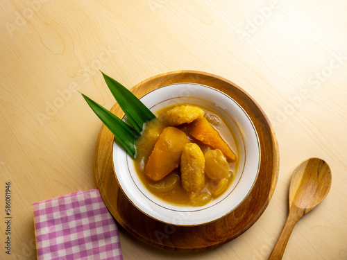 close up banana and ubi kolak with coconut milk. kolak pisang ubi for breakfasting in ramadhan. popular snack and sweets photo