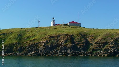 Snake Island in peacetime, sunny, the island is close, buildings and a lighthouse are visible. Black Sea, Ukraine. photo