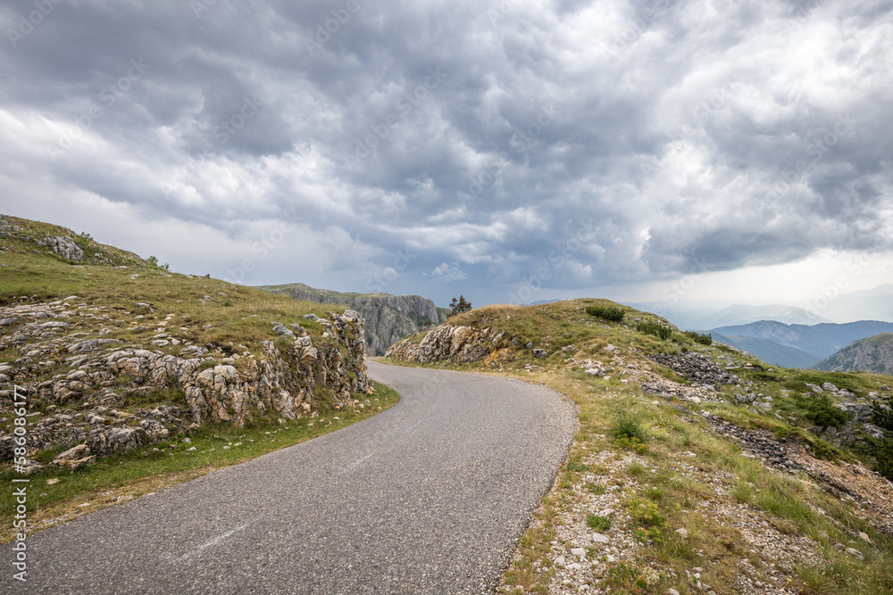 Empty road in highlands of Montenegro in stormy weather.