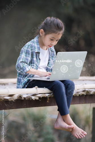 A girl is using a laptop computer for education and learning online.