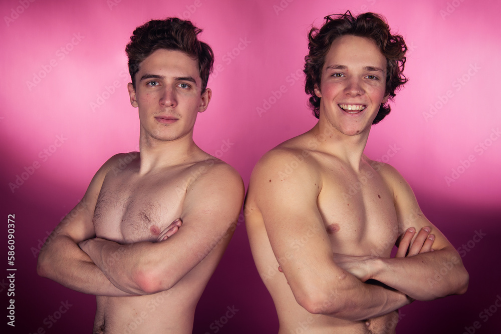Two young attractive students are posing in the studio. Two young attractive students are posing in the studio.