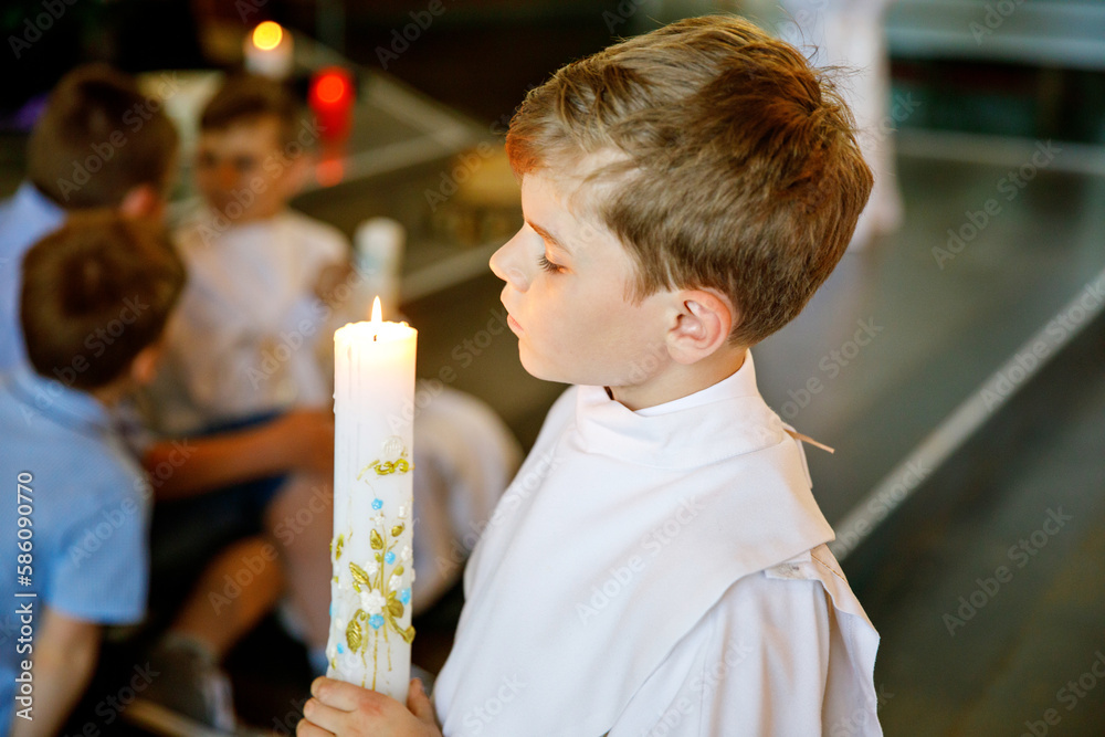 Little kid boy receiving his first holy communion. Happy child holding