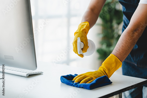 people doing cleaning are using cloths and spraying disinfectant Wipe the desk and floor in the office room..cleaning staff.cleaning maid