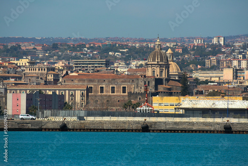 Cupola della cattedrale del duomo di Catania e cupola della Badia di Sant'Agata, fotografate dal porto di Catania con il mare in primo piano  photo
