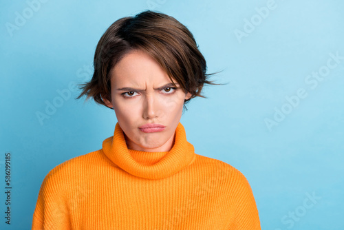 Cuadro en lienzo Portrait of unsatisfied offended girl pouted lips sullen face isolated on blue c