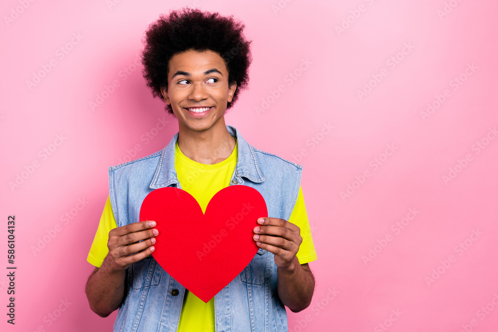 Photo of cheerful glad man hipster wear stylish clothes hold red paper card interesting offer empty space isolated on pink color background Photo of cheerful glad man hipster wear stylish clothes hold red paper card interesting offer empty space isolated on pink color background