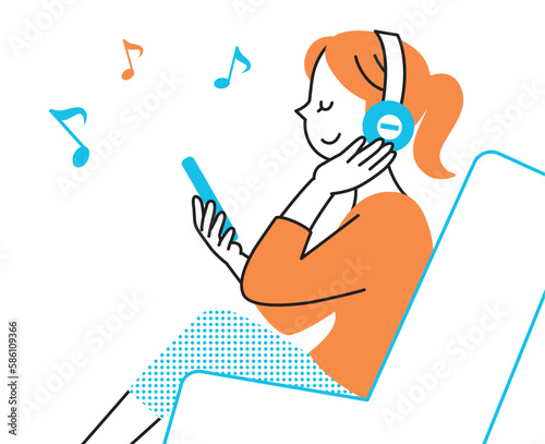 横向きでヘッドフォンで音楽を聞く女性