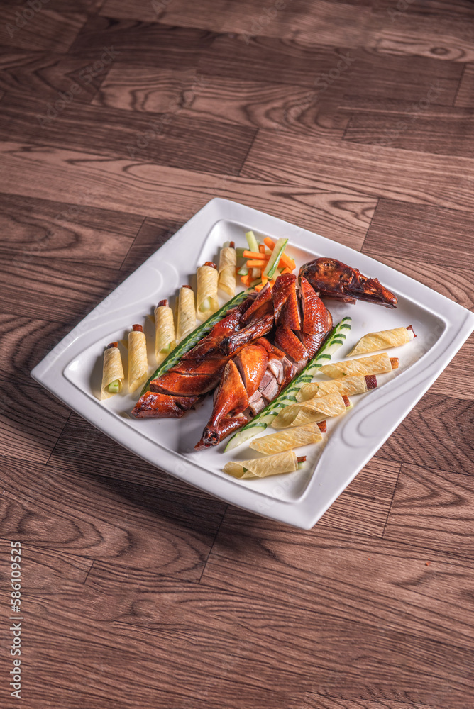 Beijing roasted whole big pipa bbq duck with crepe skin roll and vegetables on wood table background asian Chinese halal banquet meat menu Beijing roasted whole big pipa bbq duck with crepe skin roll and vegetables on wood table background asian Chinese halal banquet meat menu