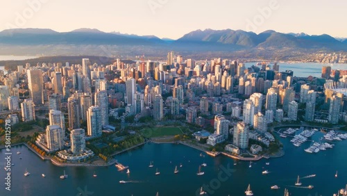 Vancouver downtown skyline aerial pullback reveal shot, BC, Canada at sunset