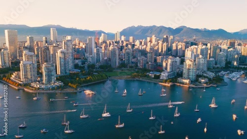 Vancouver downtown skyline aerial pullback reveal shot, BC, Canada at sunset
