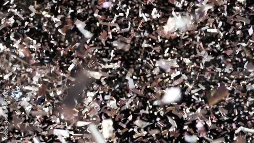 People dancing in nightclub. It's raining confetti on the crowd at the party area