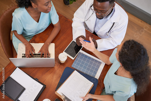 Overhead shot of medical team discussing admin and healthcare management