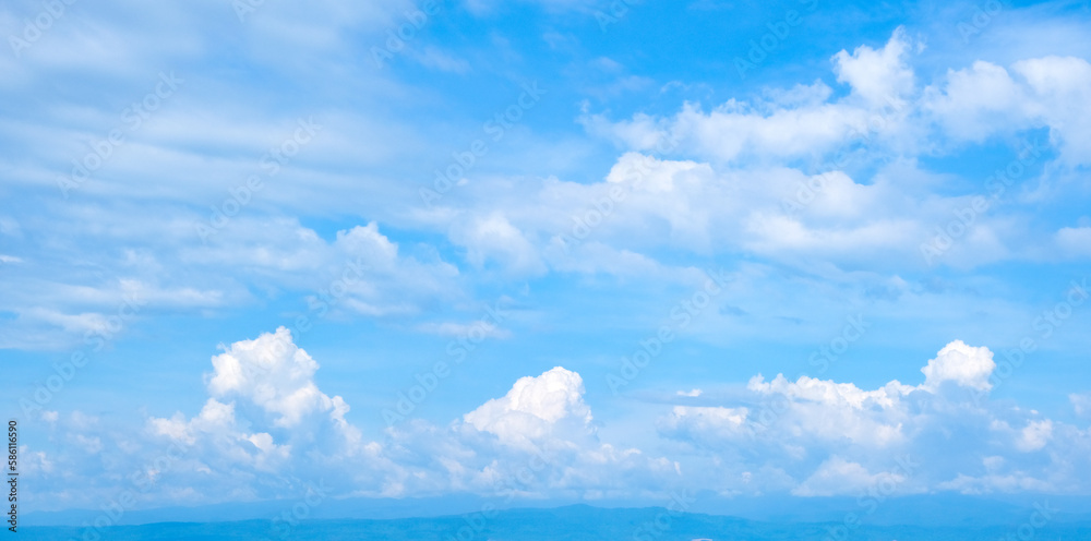 Fototapeta Panorama of a blue sky with lots of clouds and bright sunlight. clear sky