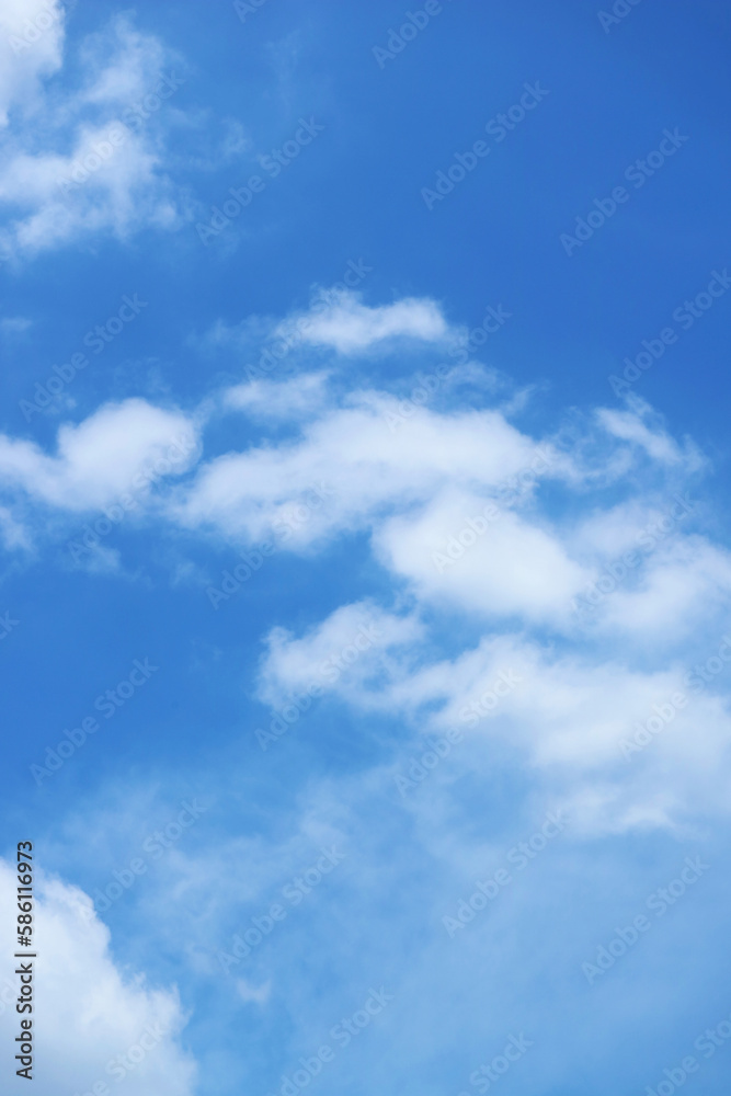White Fluffy Clouds Flowing on Vibrant Blue Sky	