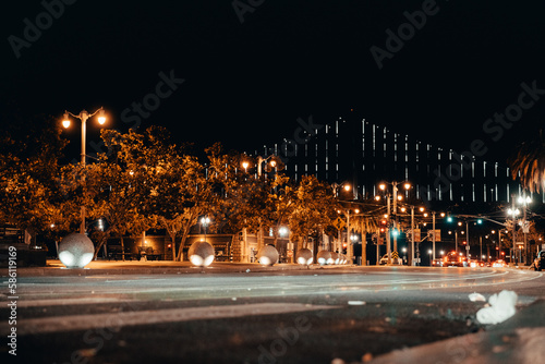 Night Photography of Streets in San Francisco. Streetlamps in the foreground, Oakland Bay Bridge in the background. Water. © Jens