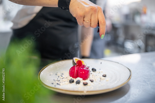 Fototapeta Naklejka Na Ścianę i Meble -  Chef cooking Dessert cake with fruit on restaurant kitchen