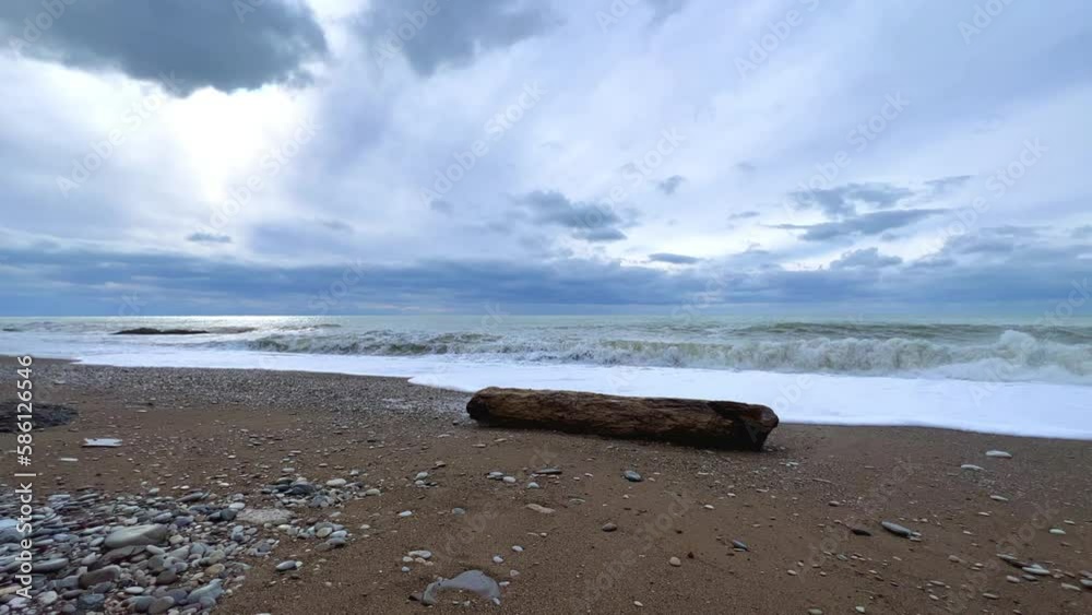 Powerful sea waves are crashing on the Black Sea coast. Waves splash on the beach with pebbles during a storm. Storm at sea. Panoramic view of the Black Sea. Russia. Sunset on the beach. 4K Powerful sea waves are crashing on the Black Sea coast. Waves splash on the beach with pebbles during a storm. Storm at sea. Panoramic view of the Black Sea. Russia. Sunset on the beach. 4K
